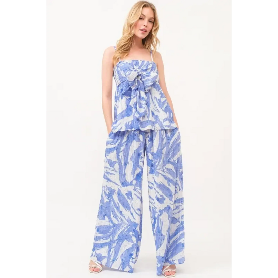 Woman wearing blue and white patterned pants sets jumpsuits short sets and rompers with wide-leg pants and sleeveless top