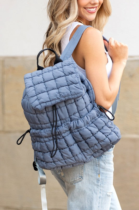 Babe Beachwaer Puffer Backpack Lightweight in blue quilted design worn by woman