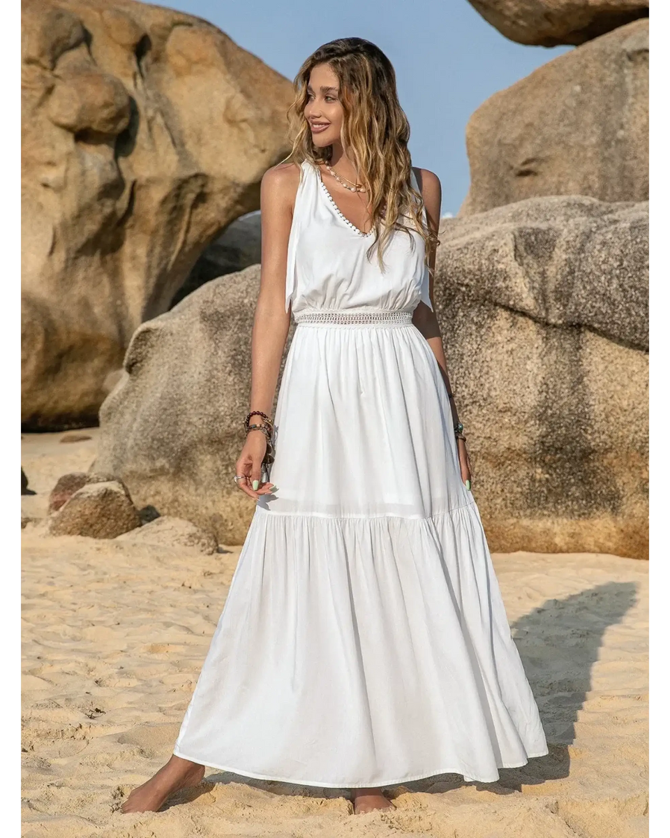 Babe Beachwear Boho summer white crochet dress maxi dress by Trendsi worn by woman on sandy beach with rocks