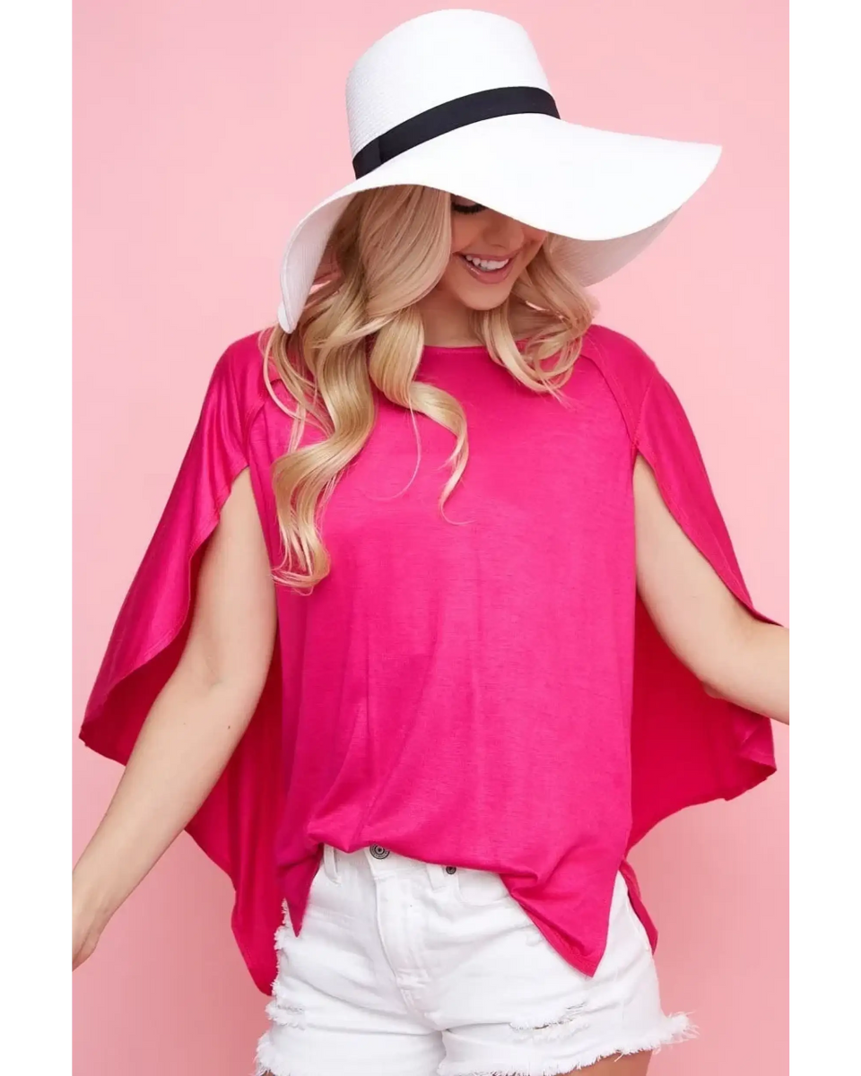 Trendsi bright pink short sleeve Cape Style Shirt with flowing cape design worn with white shorts and a wide brim hat