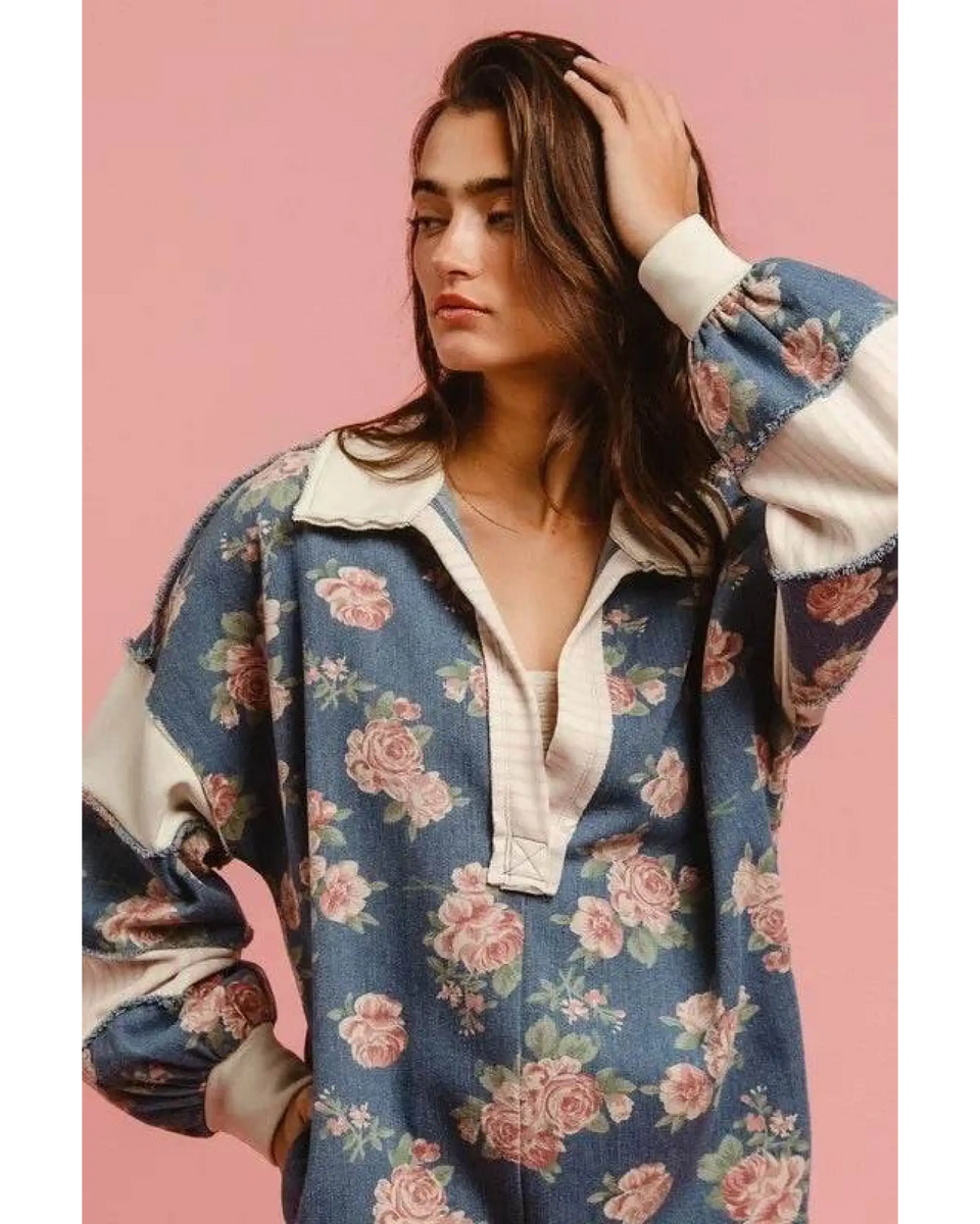 Woman wearing a Babe Beachwear contrast collar summer romper with floral print and long puff sleeves