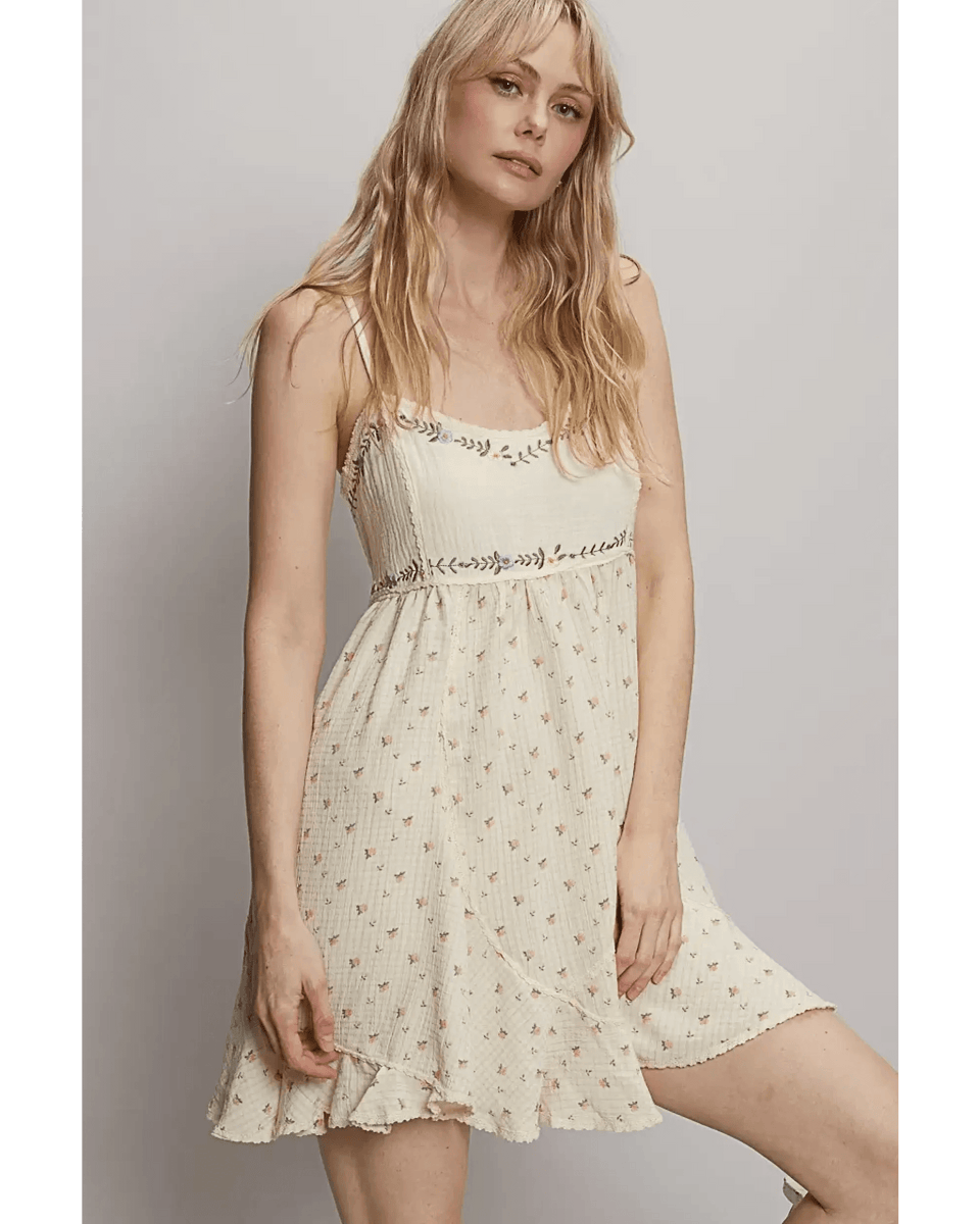 Trendsi cream summer cami dress with floral print and ruffled hem worn by model