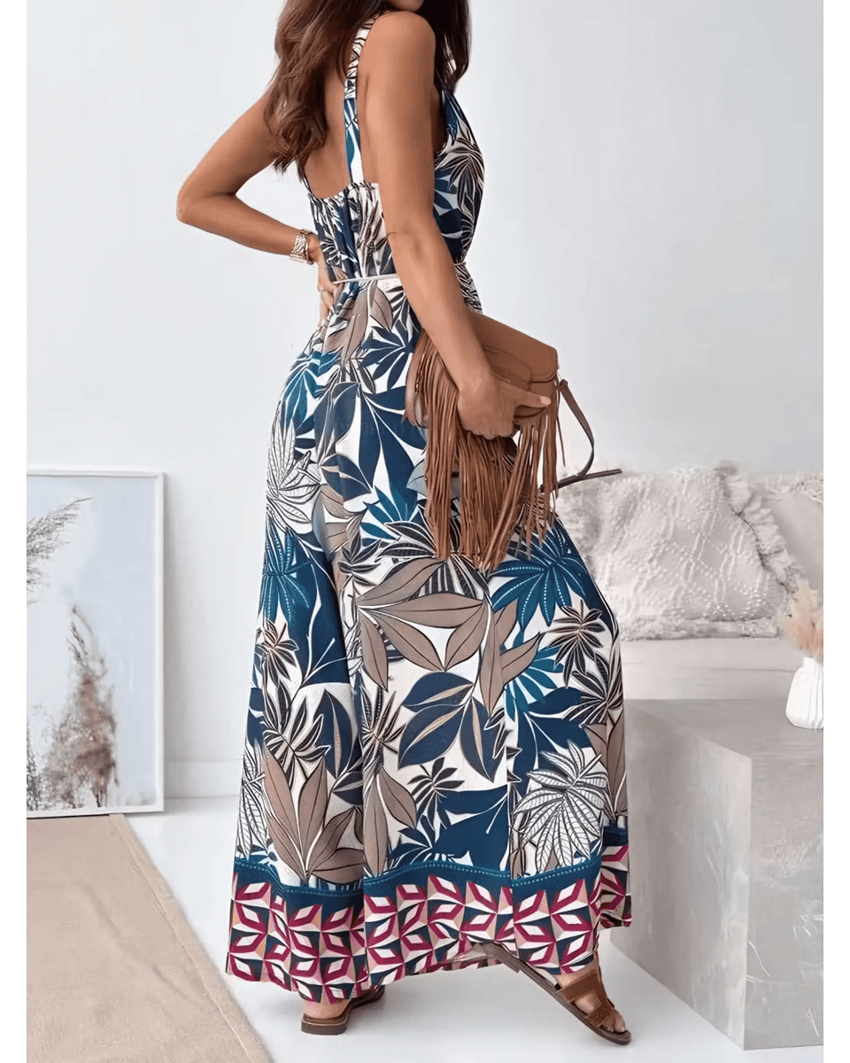 Trendsi Earth Toned Tropical Jumpsuit with sleeveless design and wide-leg pants worn with brown fringe bag