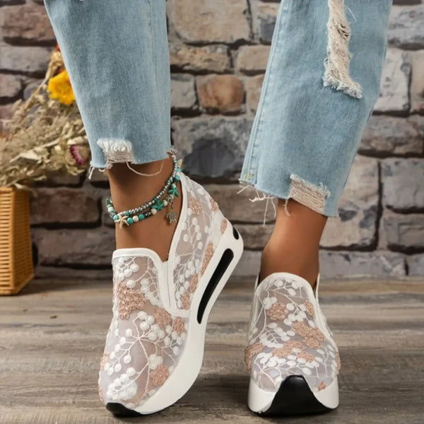 Trendsi slip on platform sneakers with white floral lace design worn with distressed jeans