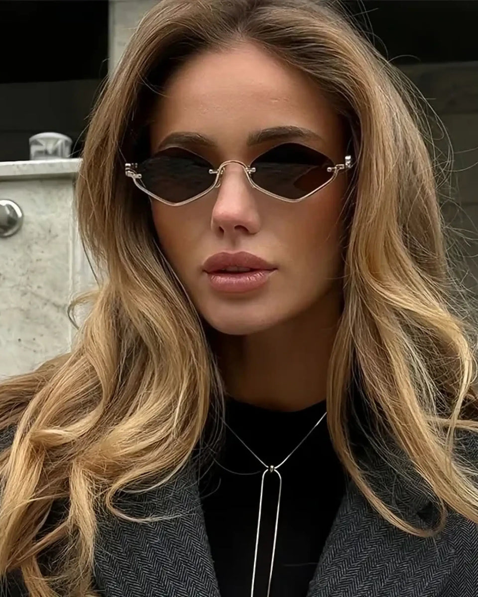Trendsi glamorous vacation sunglasses with unique geometric black lenses worn by a woman with long blonde hair