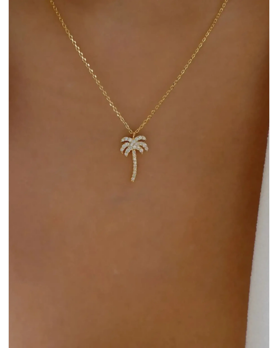 gold palm tree pendant necklace with sparkling stones on delicate chain