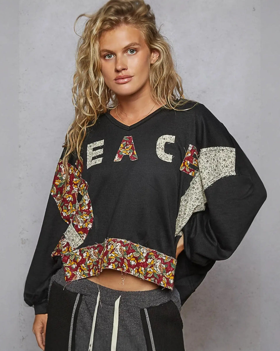 Black cropped sweatshirt with floral patches from Rock the Bloom collection