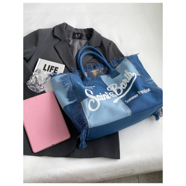 Large resort tote bag with fringe in blue tones featuring Saint Barth logo and summer paradise text