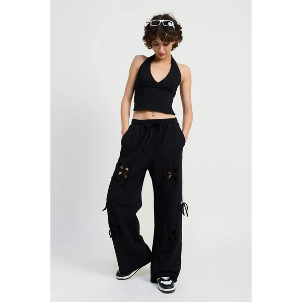Emory Park laser cutout cotton beach pants in black wide leg style worn with black halter top