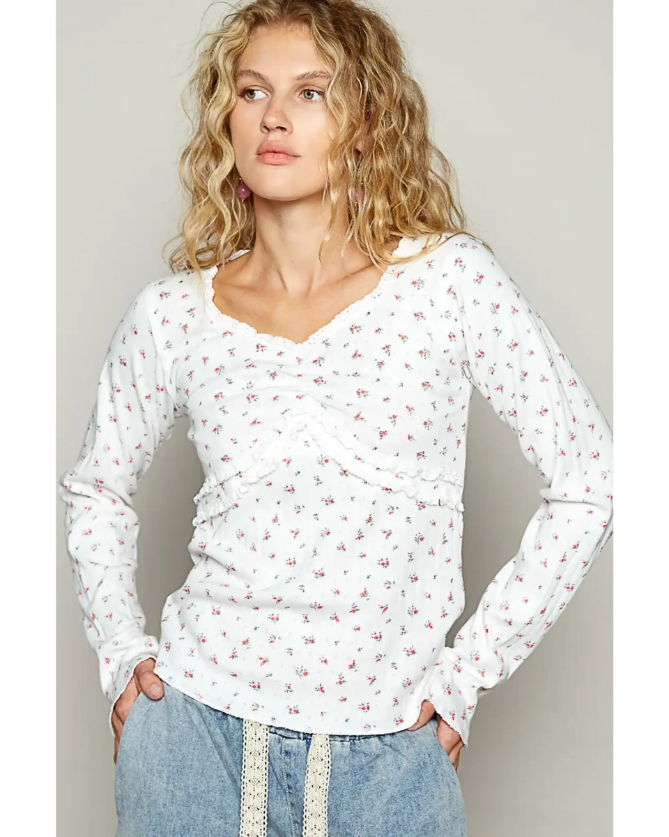 white long sleeve beachwear top with small floral print worn by model