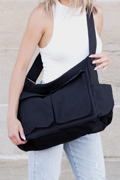 Nova Oversized Canvas Messanger Bag by Babe Beachwaer in black worn crossbody on woman