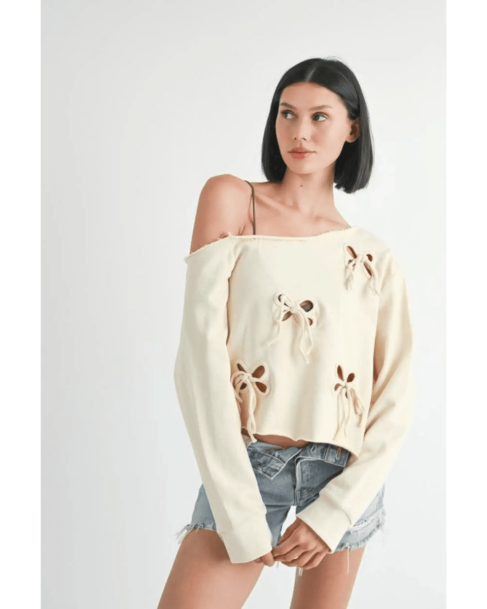 Emory Park Off Shoulder Distressed Top in cream with floral cutouts worn with denim shorts