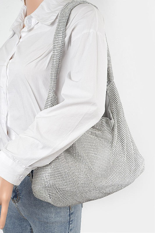 Artini Accessories Quilted Shoulder bag in silver metallic worn on shoulder with white shirt and jeans