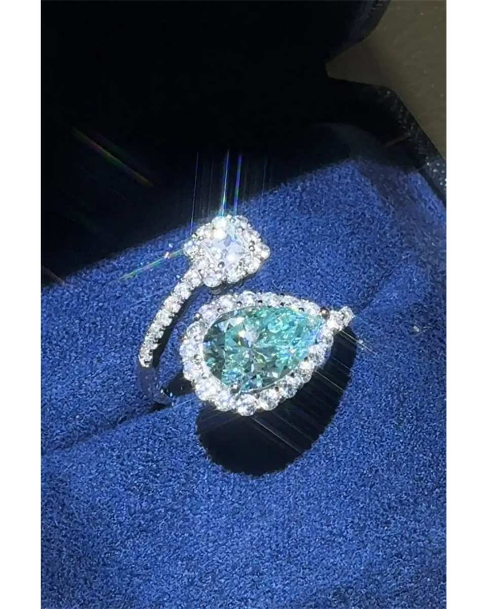 Babe Beachwear 2 carat pear shaped Bypass ring sparkle with a blue gemstone and diamond accents on silver band