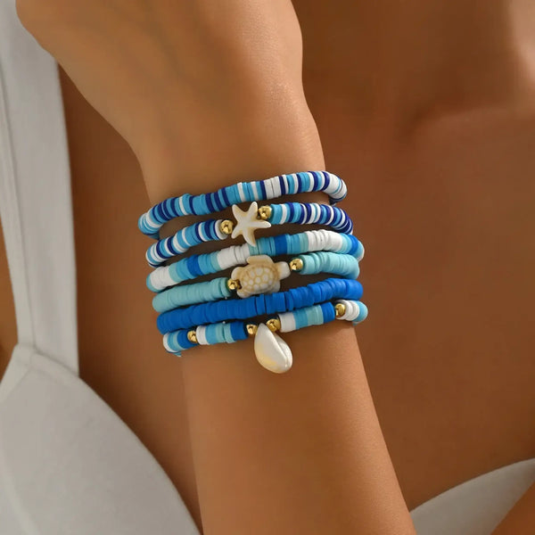 Trendsi blue stackable beach bracelets with starfish and shell charms on wrist