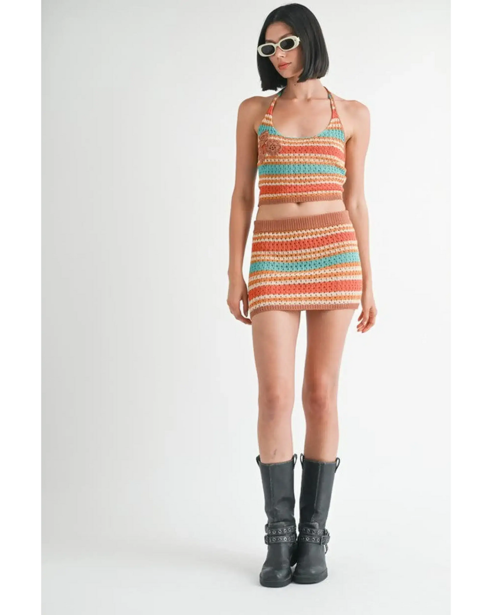 woman Emory Park colorful crochet two piece outfit with halter top and mini skirt styled with black boots