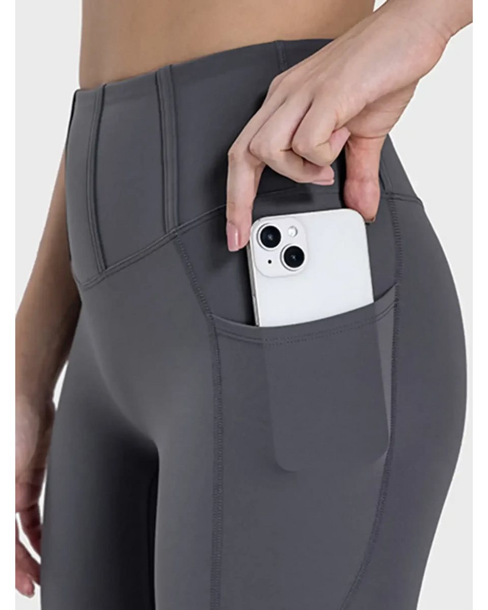 women's active leggings with pockets in dark gray showing phone stored in side pocket