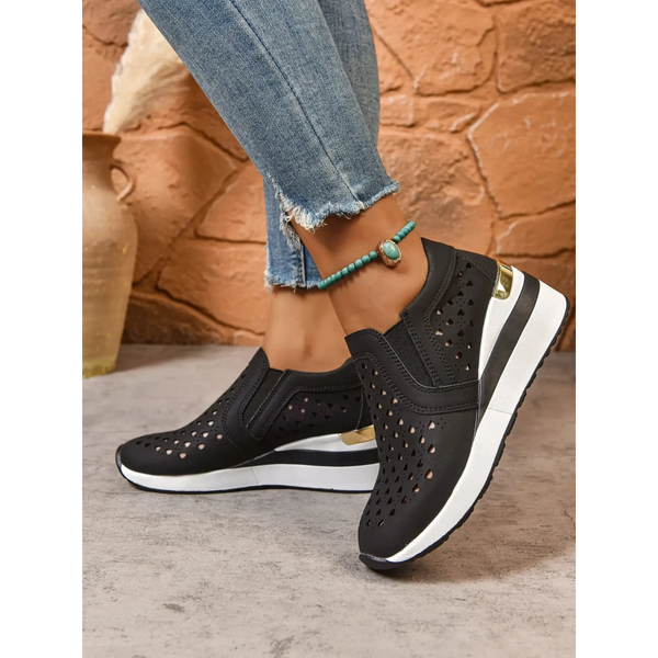 Trendsi women's breathable wedge sneakers in black with white sole and gold accent worn with jeans