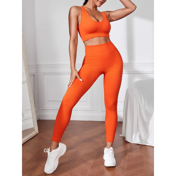orange women's compression leggings set in bright orange with matching sports bra and white sneakers