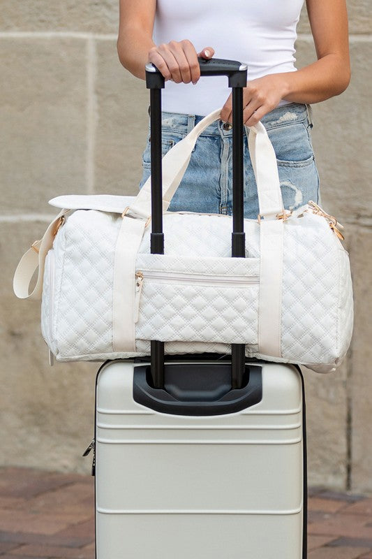 Babe Beachwear white quilted Zahra carry on overnight bag attached to silver hard suitcase