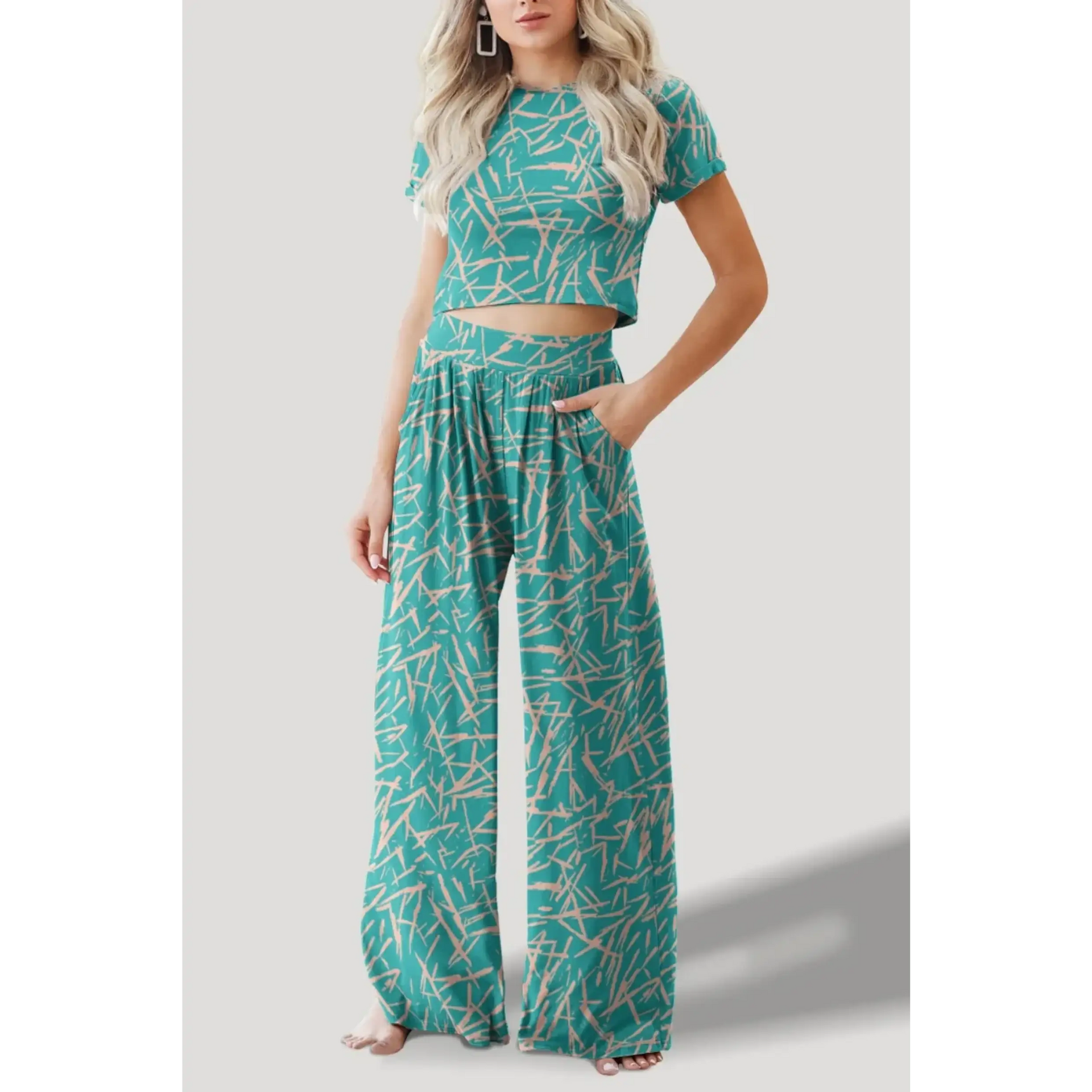 Woman wearing green patterned Pants and Shorts Sets with a matching short sleeve crop top