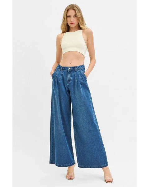Woman wearing comfort casual denim jeans and shorts wide-leg blue jeans with a cropped top