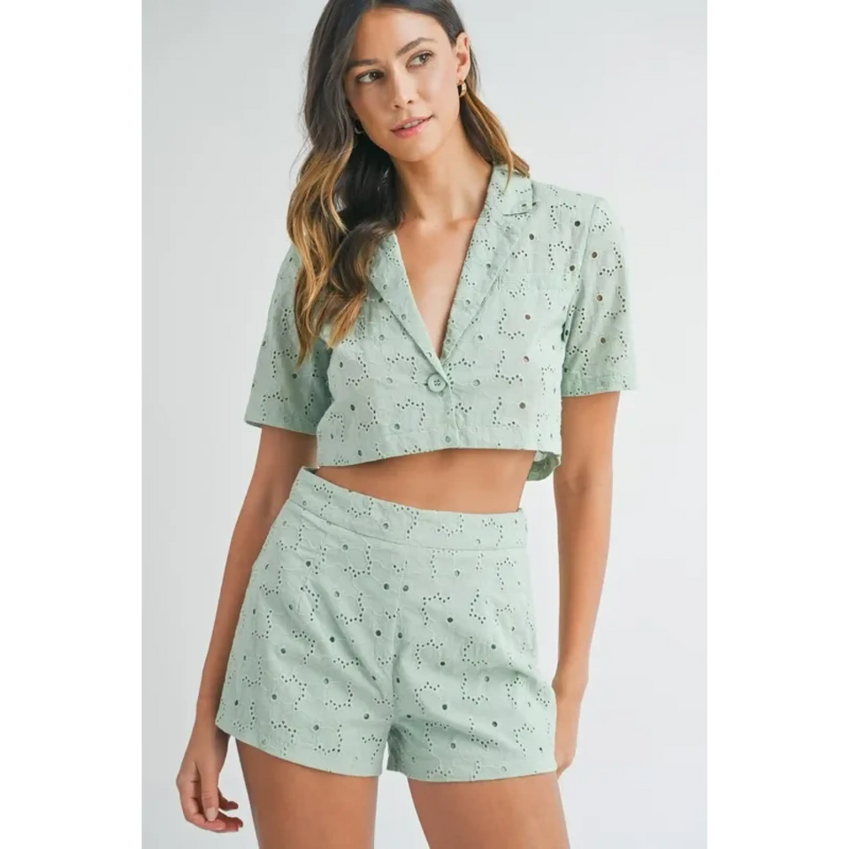 Woman wearing a light green eyelet crop blazer and matching shorts from women's summer short sets collection