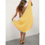 Beach Babes yellow coverup with colorful trim held by woman in white bikini at the beach