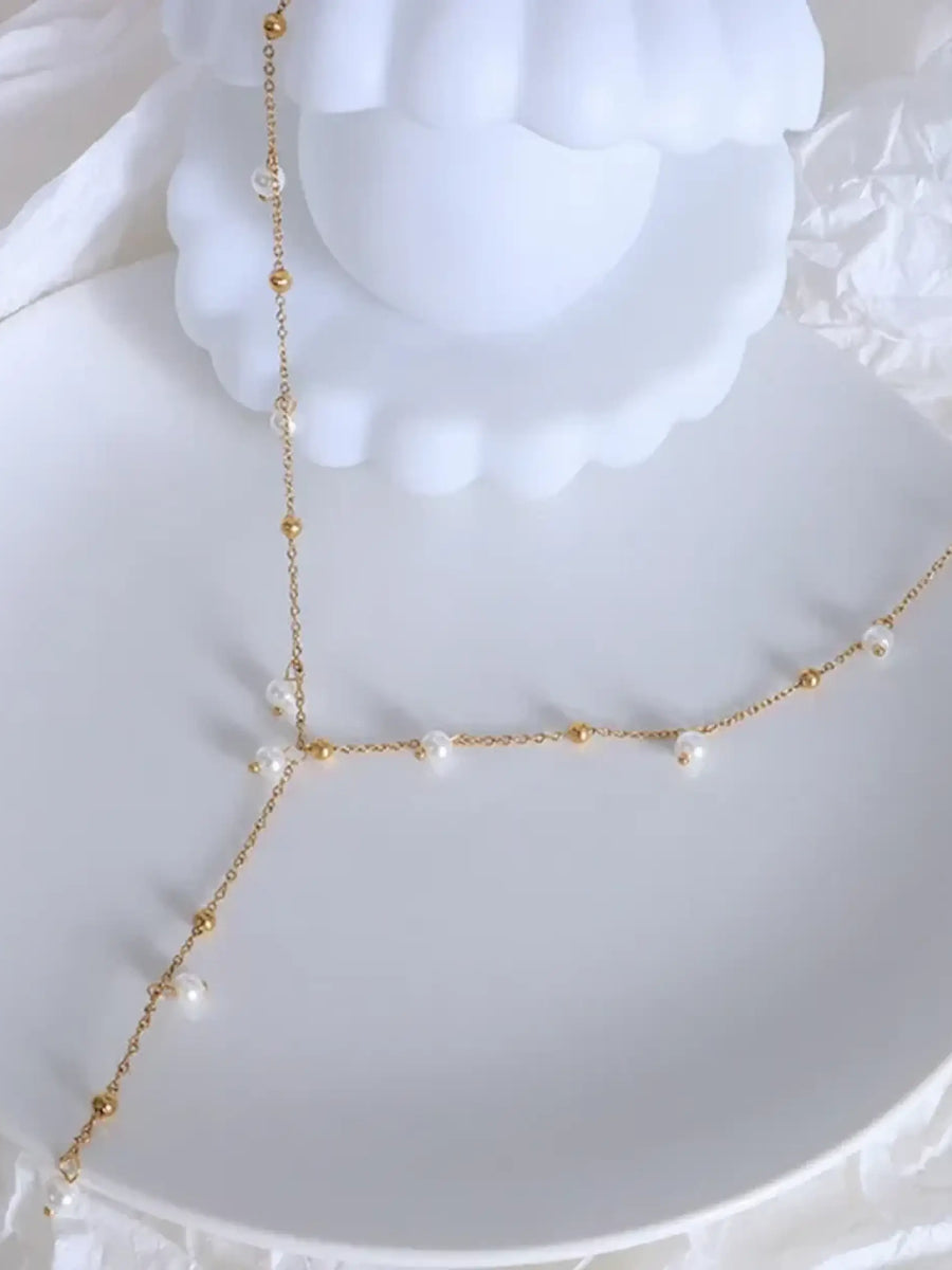 Trendsi 18K gold plated pearl necklace with delicate chain and small white pearls on white dish