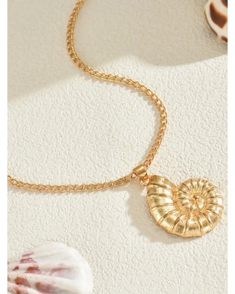 Trendsi 18K gold shell pendant necklace with a detailed spiral shell design on a textured surface