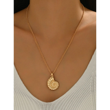 18K gold shell pendant necklace by Trendsi worn around neck with delicate chain and spiral shell charm