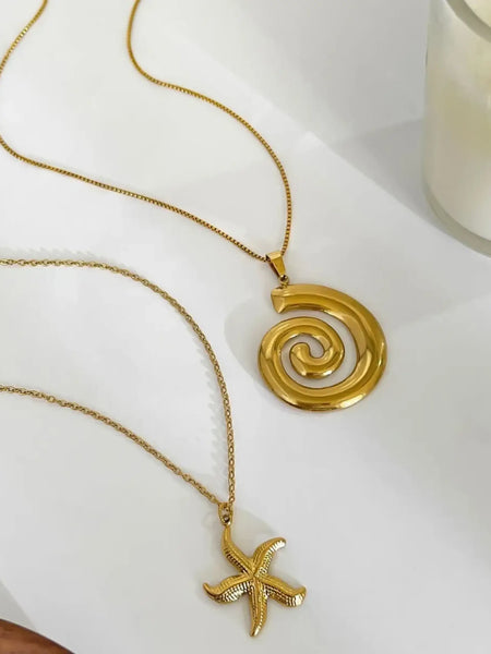 18k gold starfish necklace by Trendsi displayed alongside another gold spiral pendant necklace