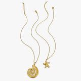 Elegant  18k gold starfish necklace displayed alongside a spiral shell pendant necklace on white background
