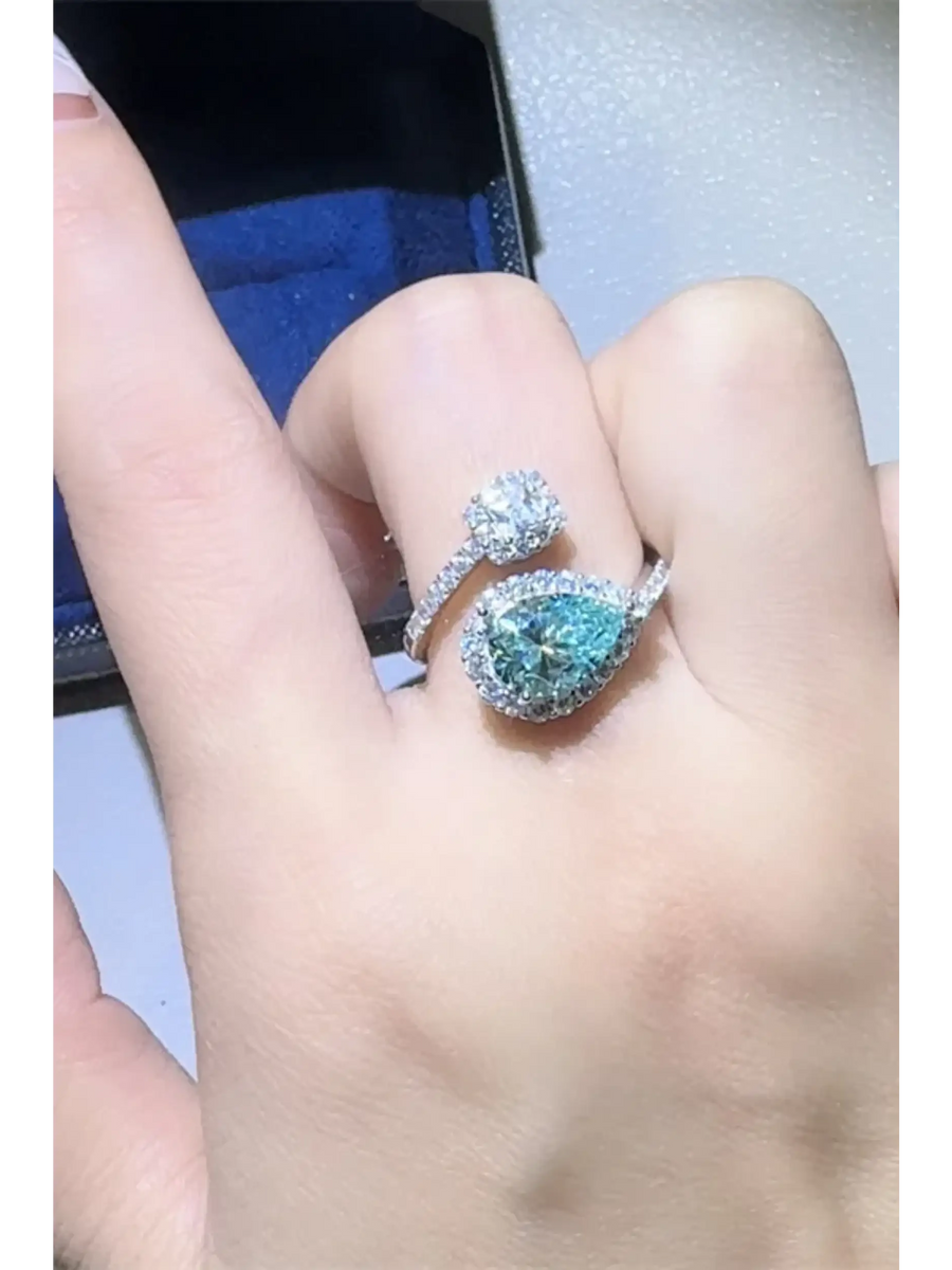 Babe Beachwear 2 carat pear shaped Bypass ring sparkle worn on finger with blue pear shaped and round gems