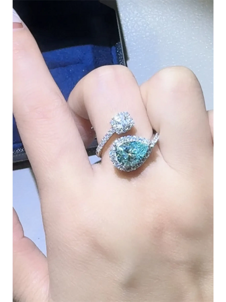 Babe Beachwear 2 carat pear shaped Bypass ring sparkle worn on finger with blue pear shaped and round gems
