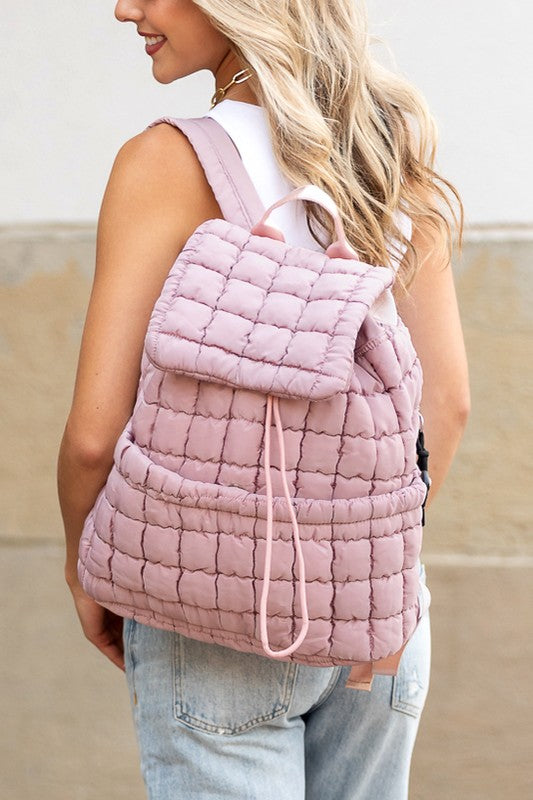 Babe Beachwear pink Puffer Backpack Lightweight worn by woman with white top and jeans