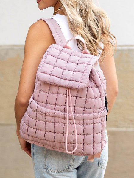Babe Beachwear pink Puffer Backpack Lightweight worn by woman with white top and jeans