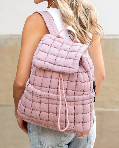 Babe Beachwear pink Puffer Backpack Lightweight worn by woman with white top and jeans