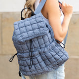 Babe Beachwaer Puffer Backpack Lightweight in blue quilted design worn by woman