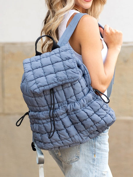 Babe Beachwaer Puffer Backpack Lightweight in blue quilted design worn by woman