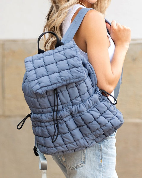Babe Beachwaer Puffer Backpack Lightweight in blue quilted design worn by woman