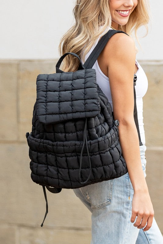Babe Beachwear Puffer Backpack Lightweight black quilted design worn by woman with blonde hair
