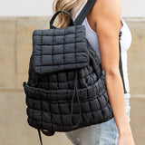 Babe Beachwear Puffer Backpack Lightweight black quilted design worn by woman with blonde hair