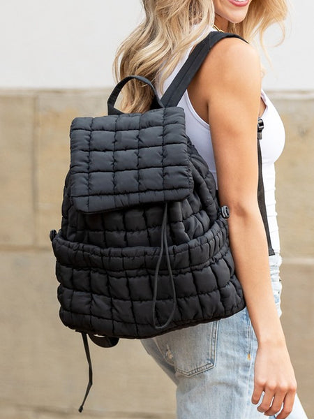 Babe Beachwear Puffer Backpack Lightweight black quilted design worn by woman with blonde hair