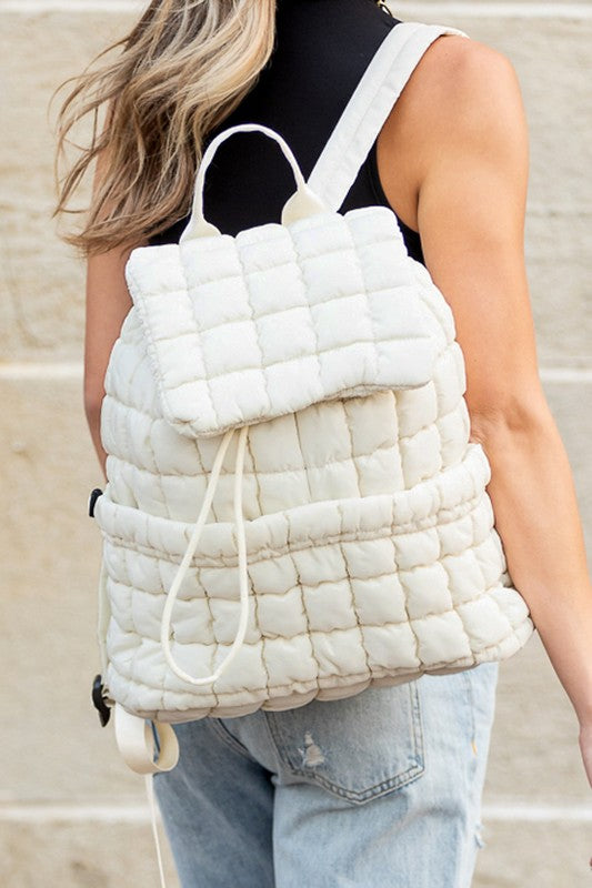 Babe Beachwear white Puffer Backpack Lightweight quilted design worn by a woman with blonde hair