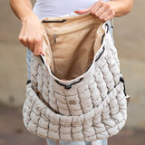 Babe Beachwear Puffer Backpack Lightweight in beige held open showing spacious interior with zippered pocket