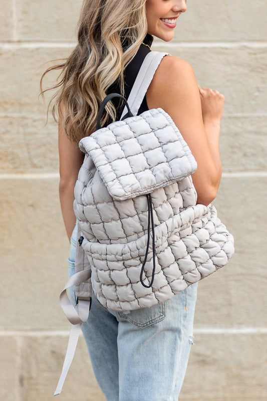 Babe Beachwear Puffer Backpack Lightweight in white worn by woman with casual outfit