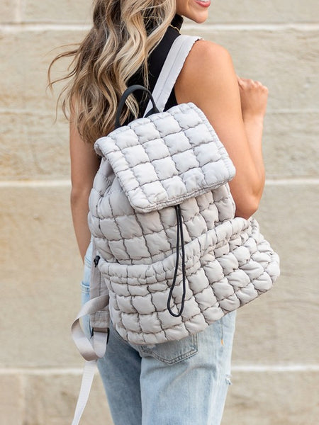 Babe Beachwear Puffer Backpack Lightweight in white worn by woman with casual outfit