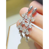 Elegant  6 Carat Drop Earrings with multiple teardrop-shaped sparkling stones held by hand