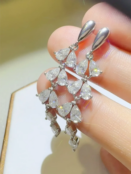 Elegant  6 Carat Drop Earrings with multiple teardrop-shaped sparkling stones held by hand